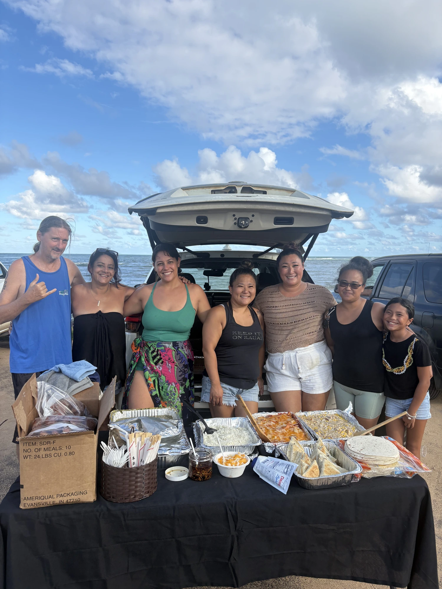 Volunteers plating hot meals at a Feed the Community service on Kauaʻi